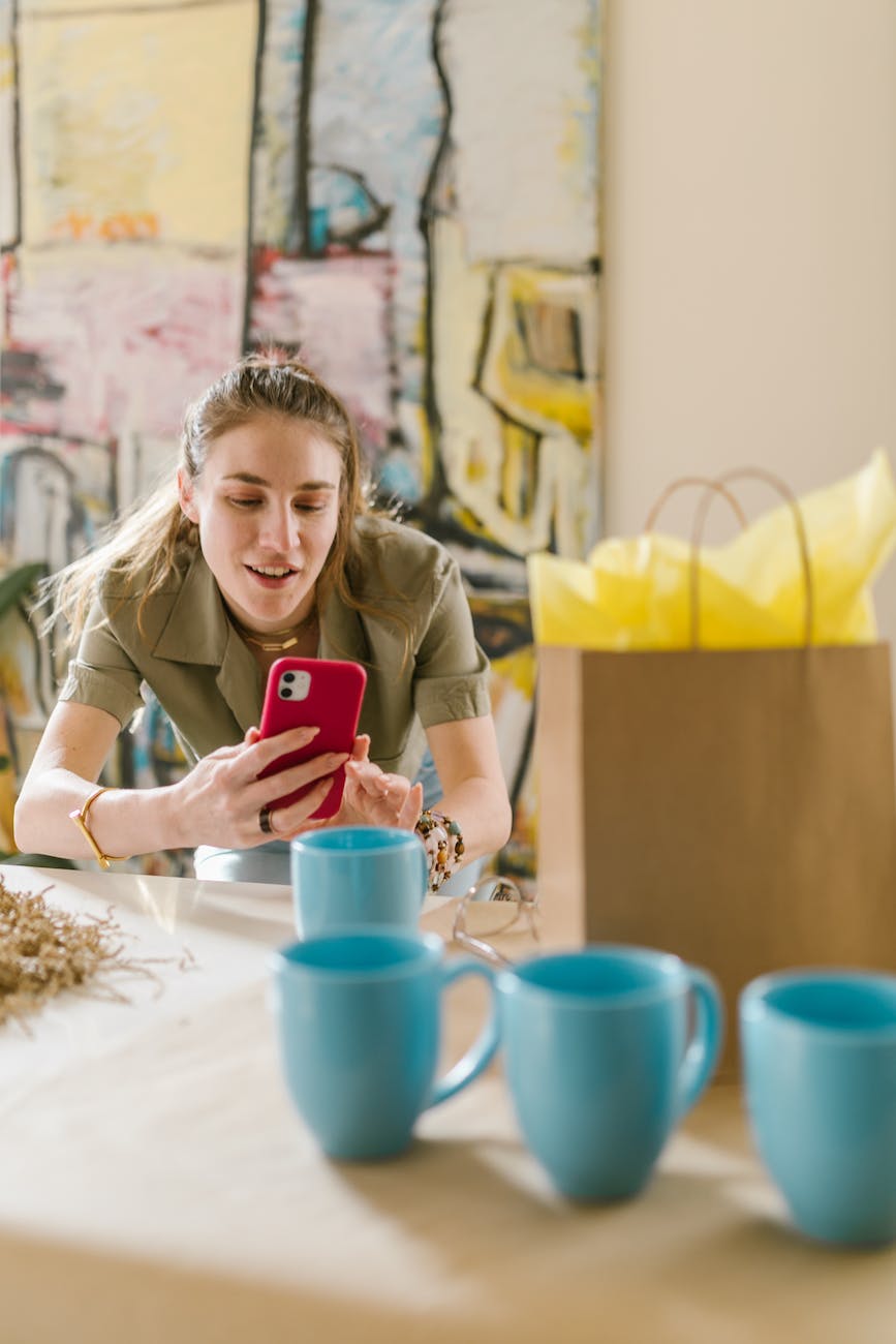 a woman taking photo of a mug