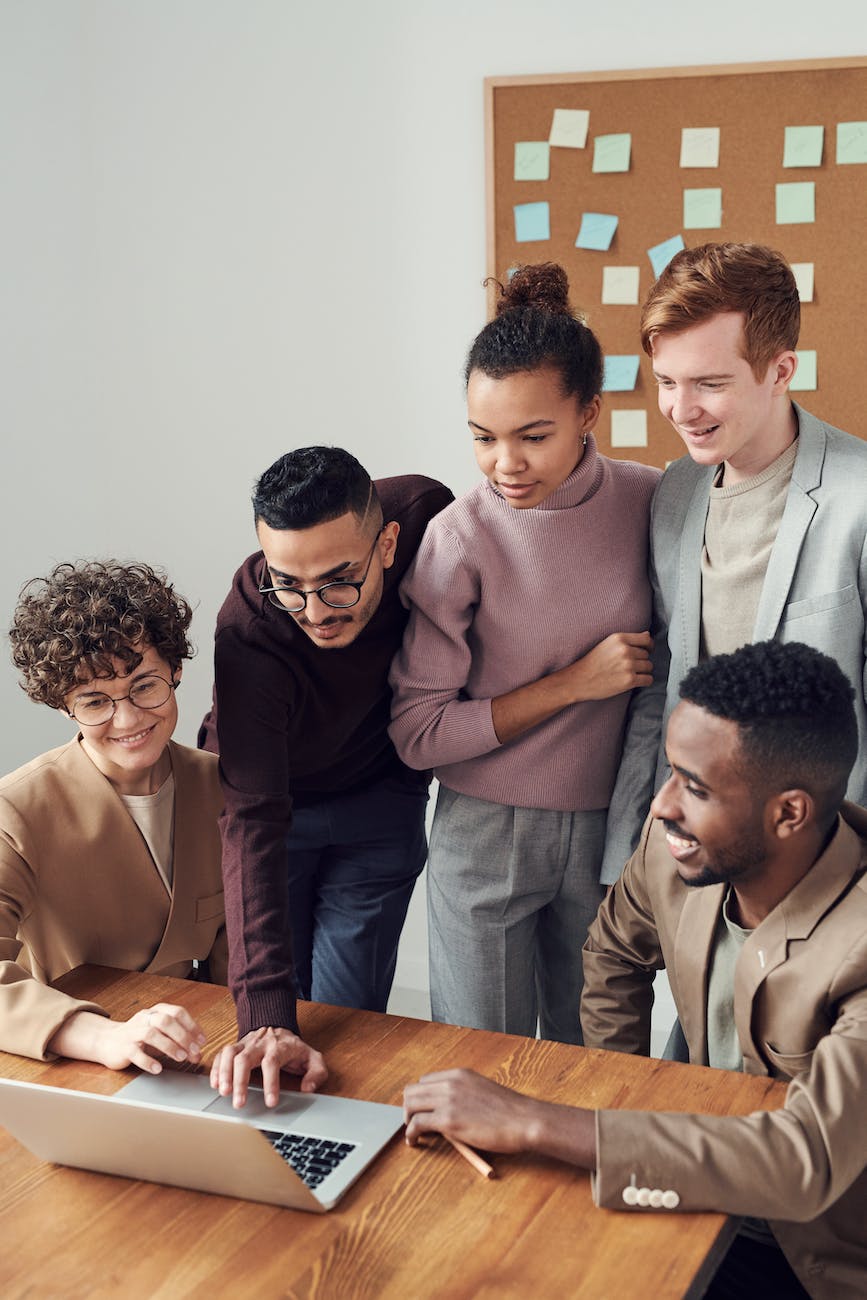 photo of people looking on laptop