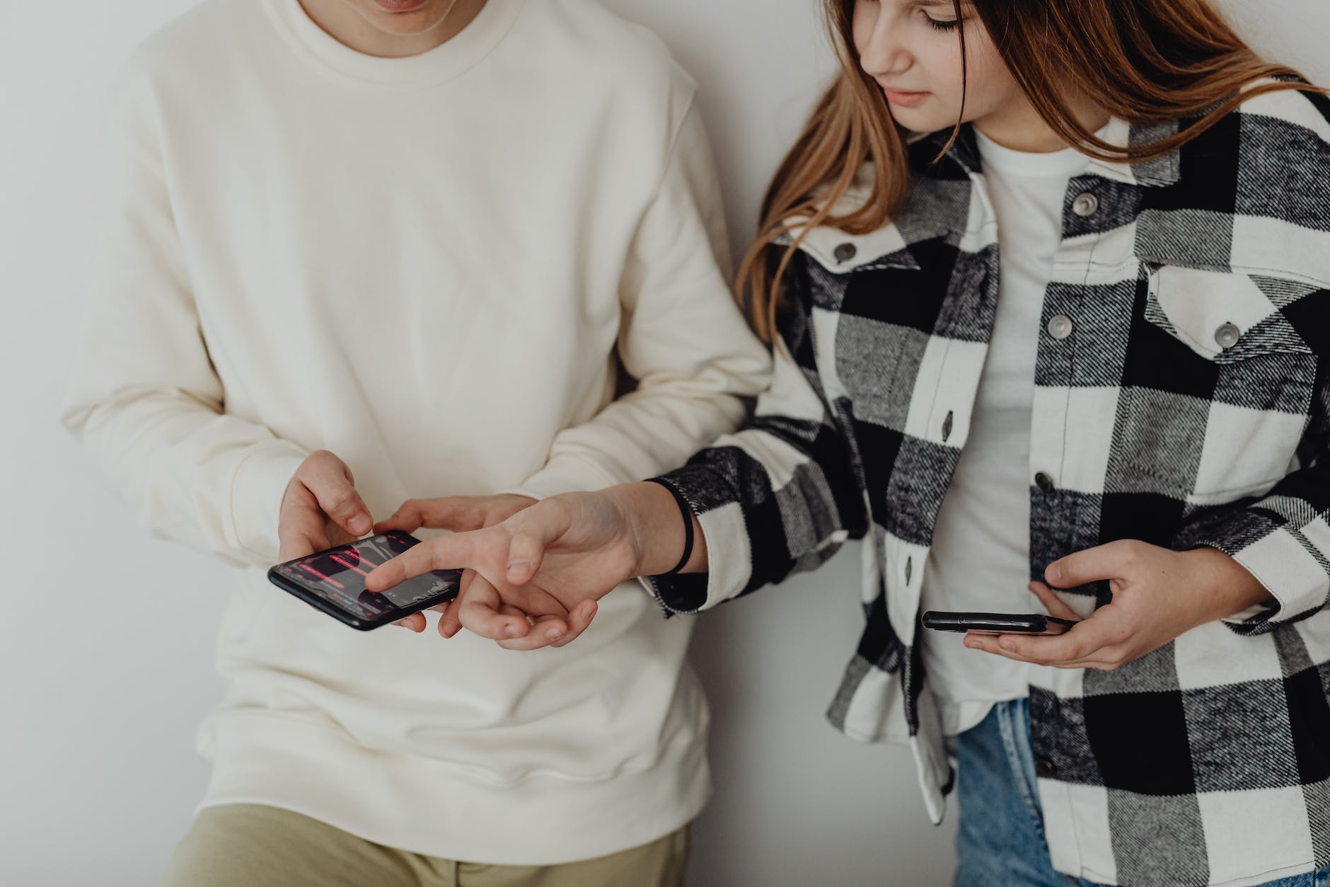 young couple looking at their smart phones